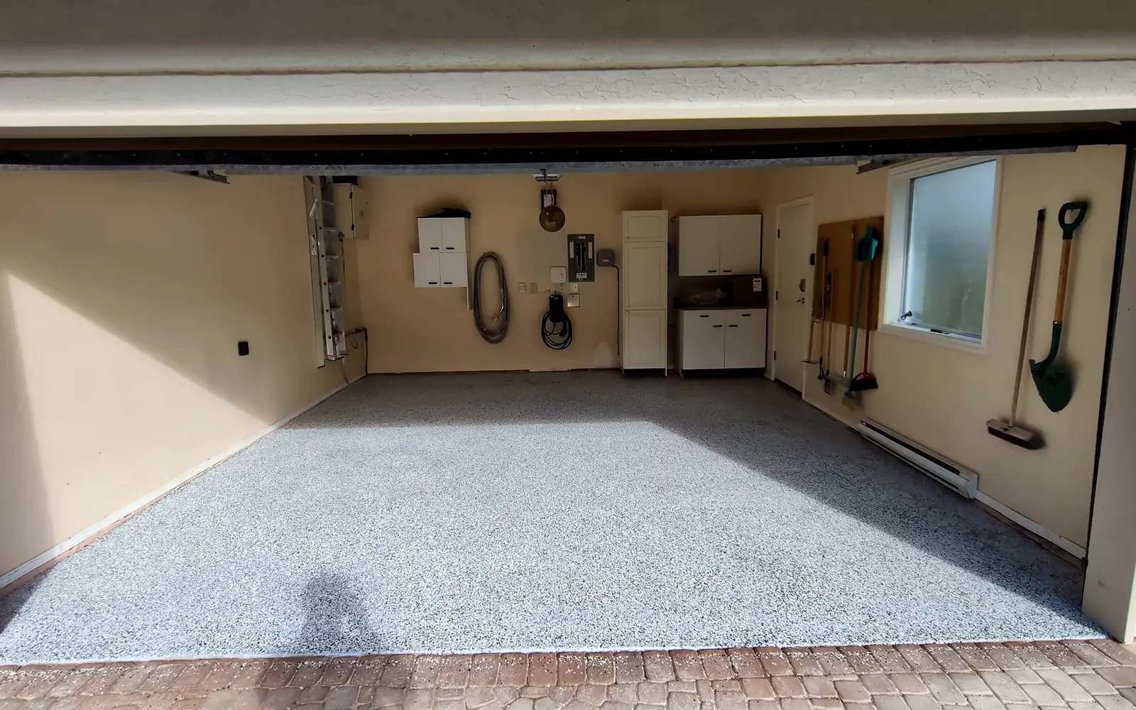 Garage floor after epoxy flake coating by Stronghold Surfaces