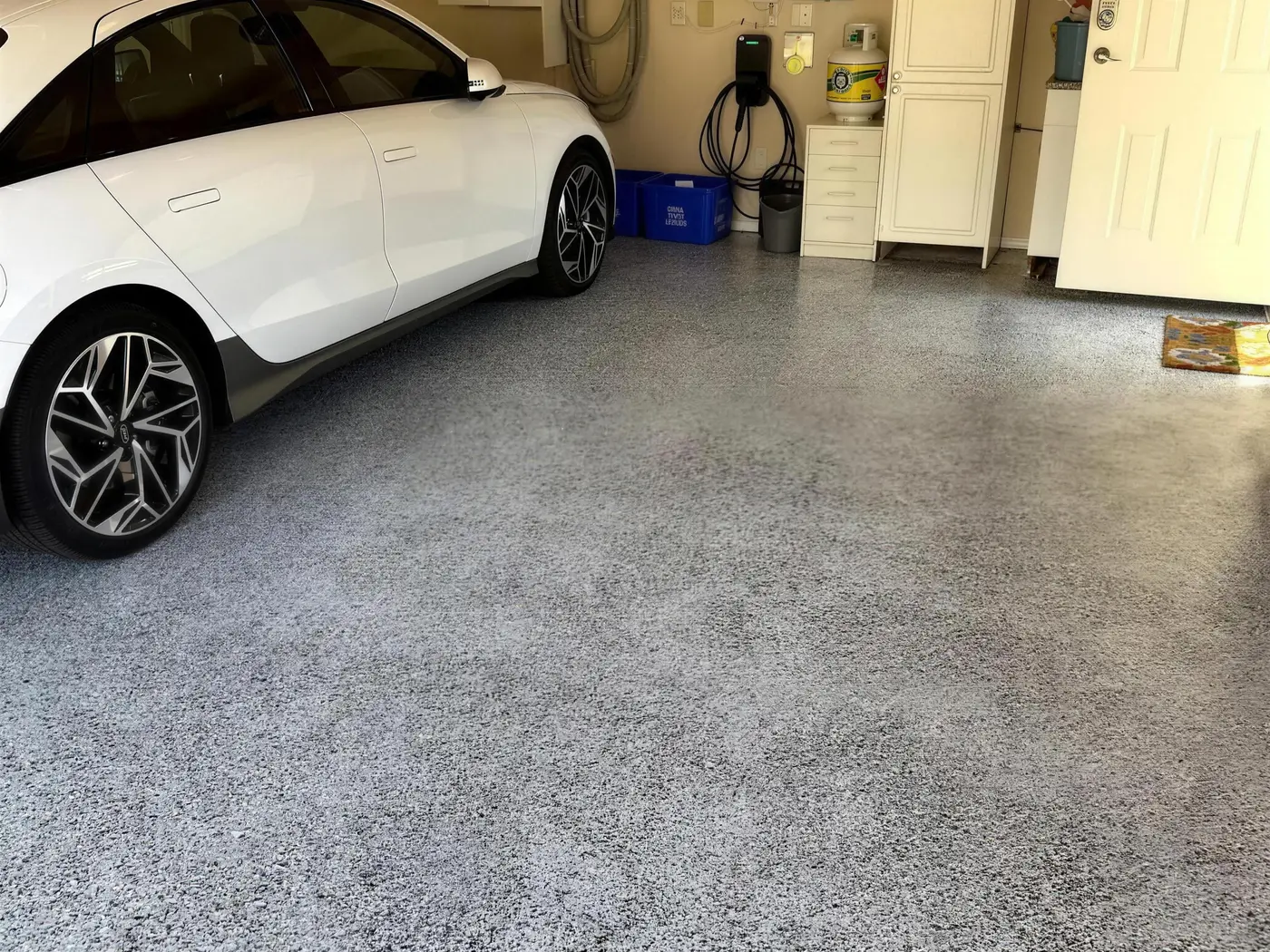 Finished epoxy flake garage floor with parked car